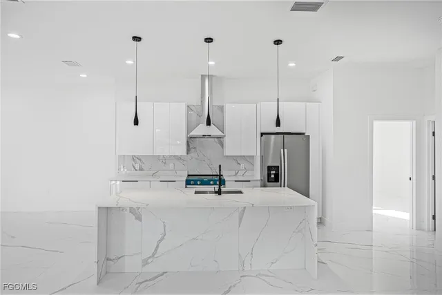 a kitchen with kitchen island a counter top space appliances and a ceiling fan