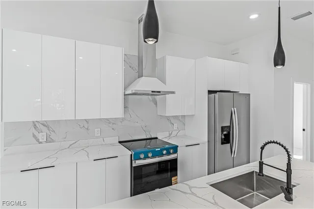 a kitchen with a stove a refrigerator and cabinets