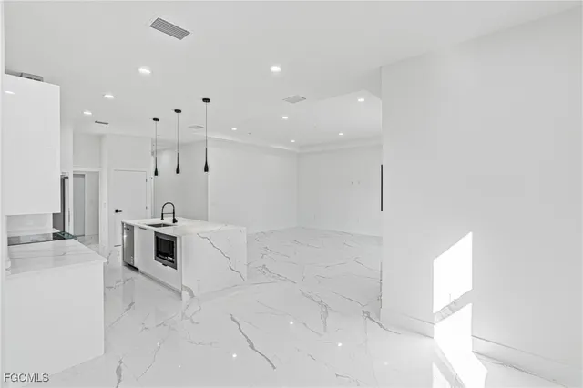 a large white kitchen with cabinets and a stove