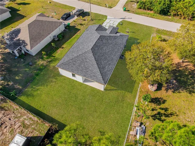 an aerial view of a house with a yard