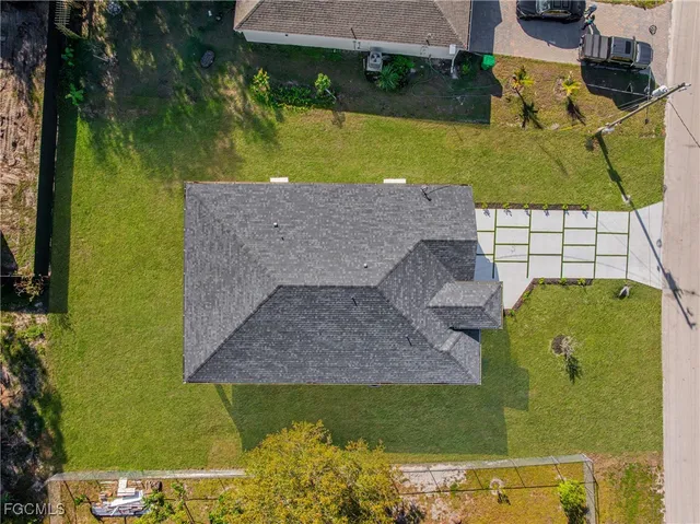 an aerial view of a house with a yard swimming pool and outdoor seating
