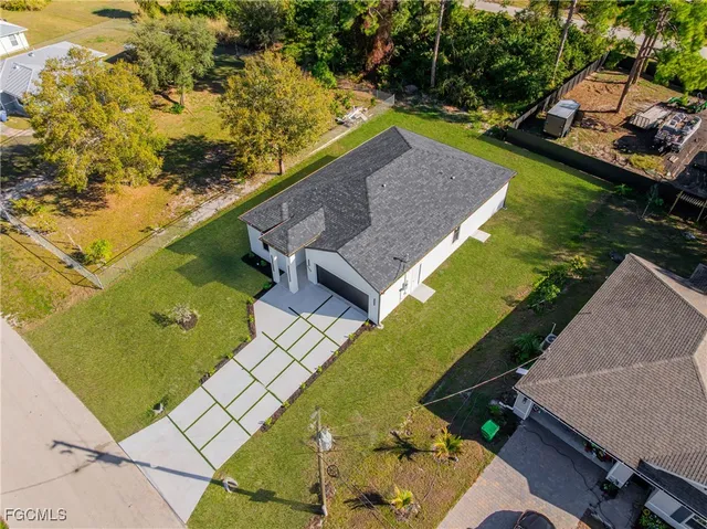an aerial view of a house with a yard
