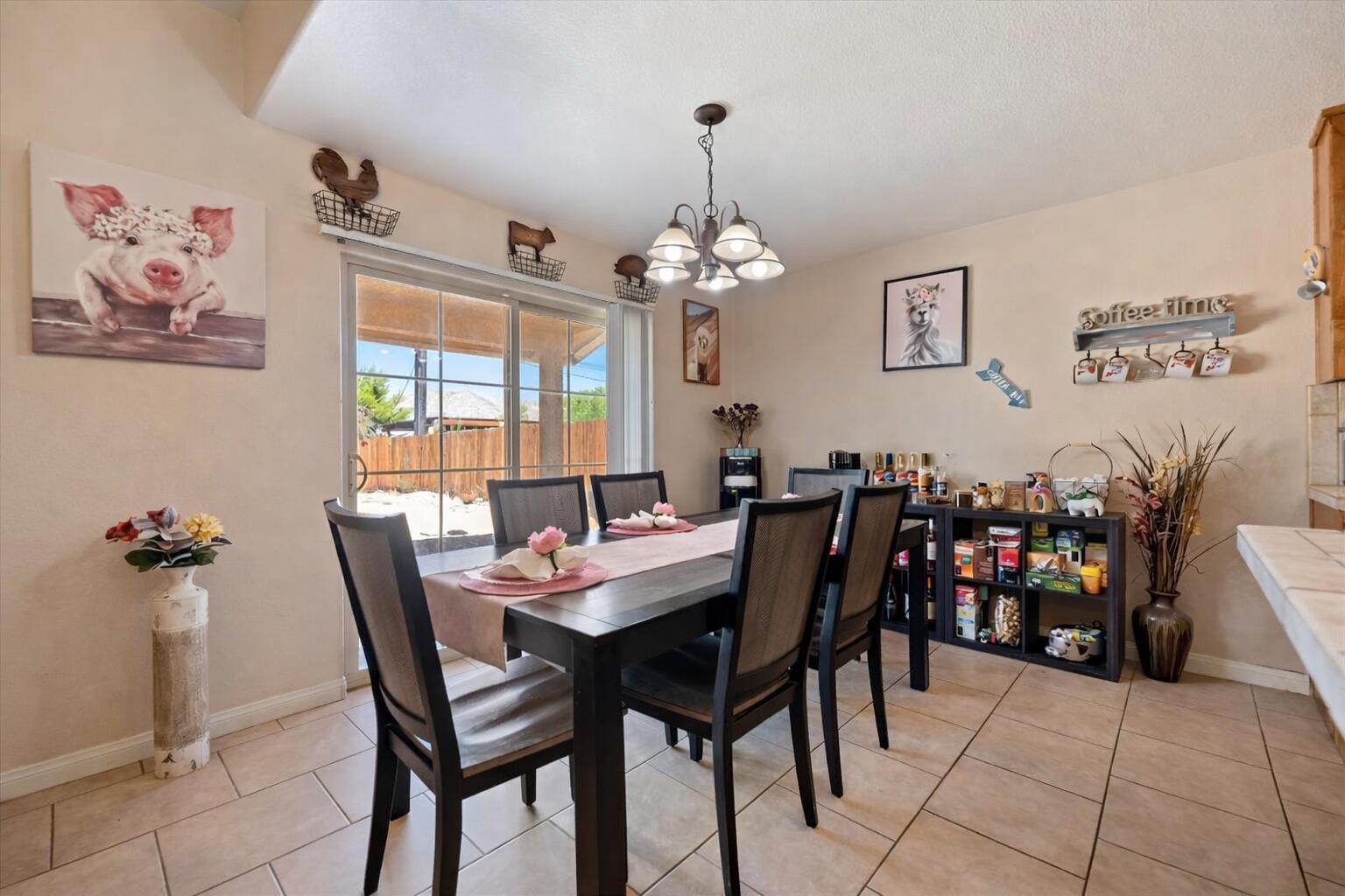 7562 Inca Trail Yucca Valley, CA 92284 - Photo 11 of 30 a view of a dining room with furniture and chandelier