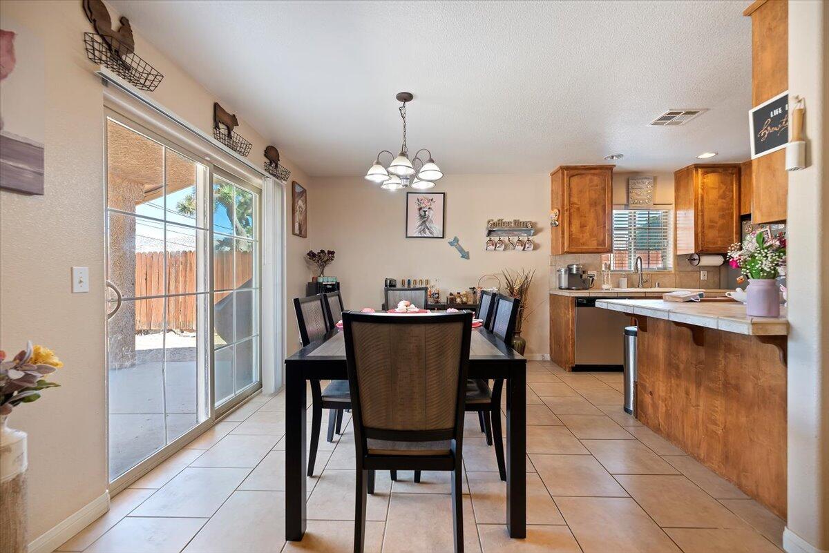 7562 Inca Trail Yucca Valley, CA 92284 - Photo 12 of 30 a view of a dining room with furniture window and outside view