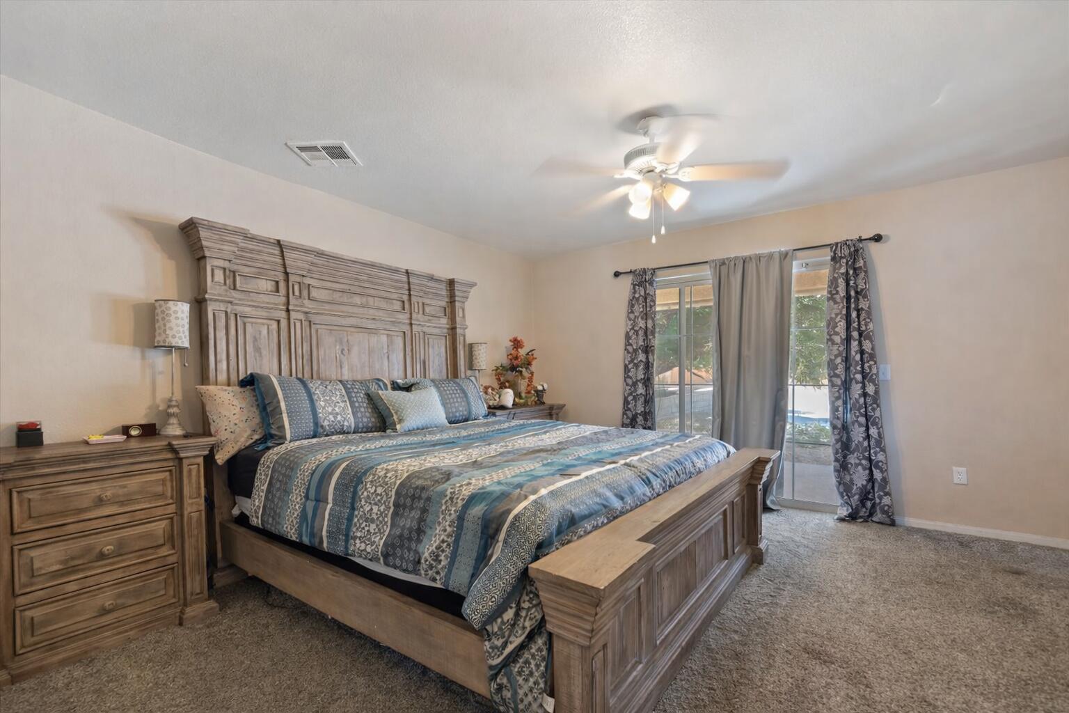7562 Inca Trail Yucca Valley, CA 92284 - Photo 17 of 30 a bedroom with a bed and a chandelier