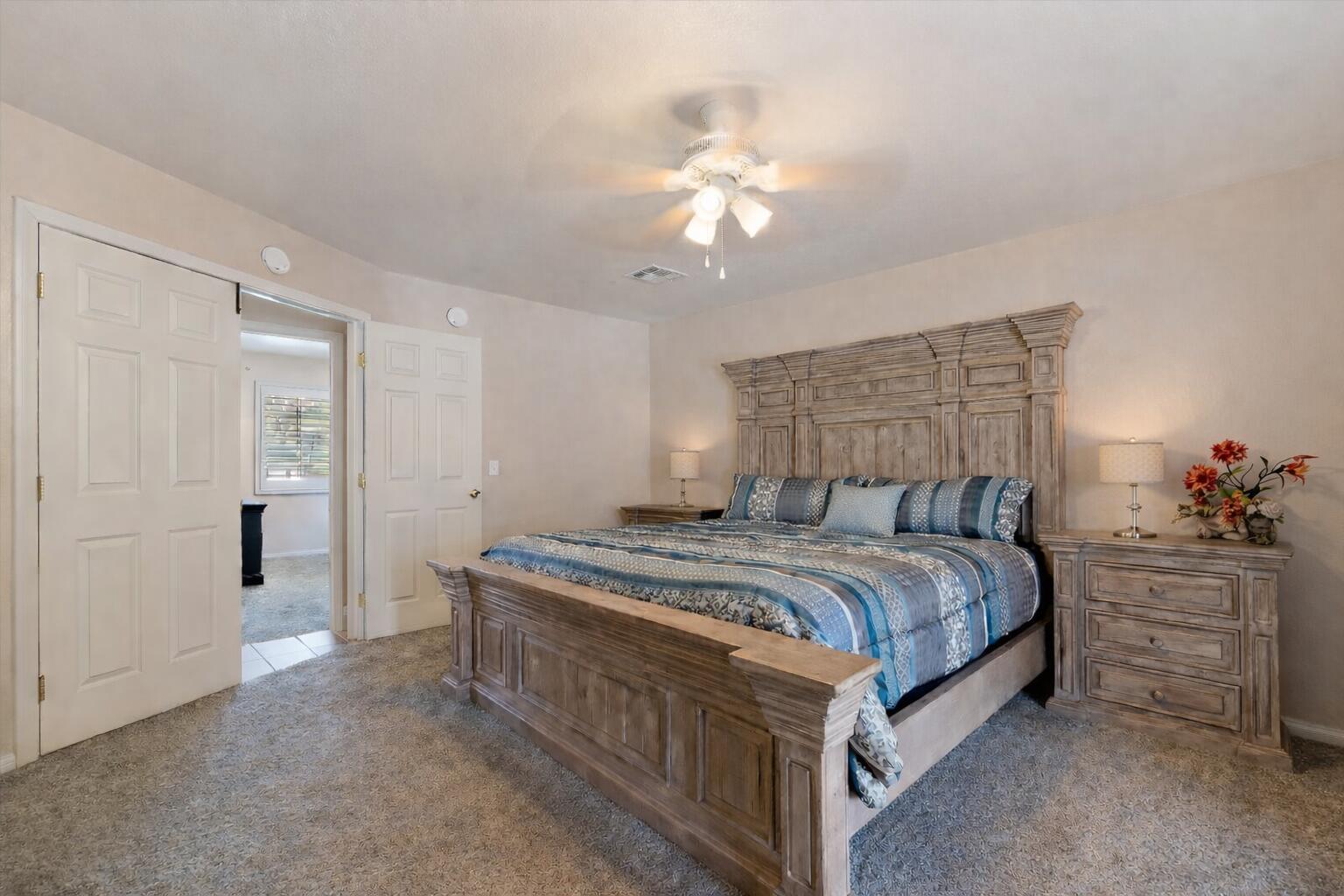 7562 Inca Trail Yucca Valley, CA 92284 - Photo 18 of 30 a bedroom with a bed and a chandelier