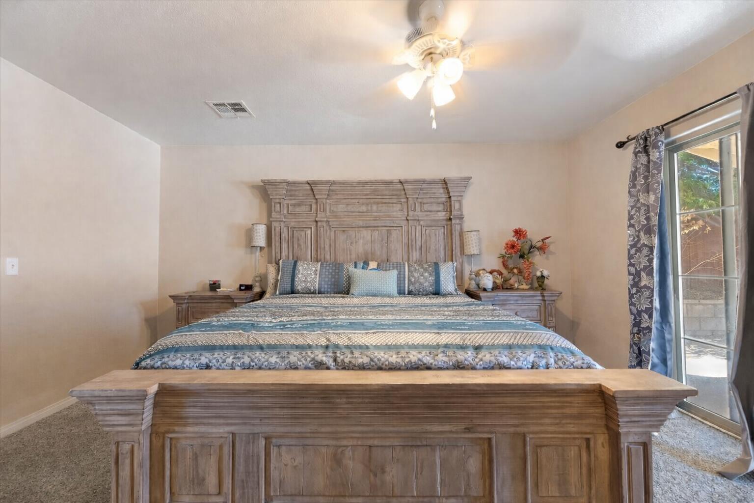 7562 Inca Trail Yucca Valley, CA 92284 - Photo 19 of 30 a bedroom with a bed and a chandelier