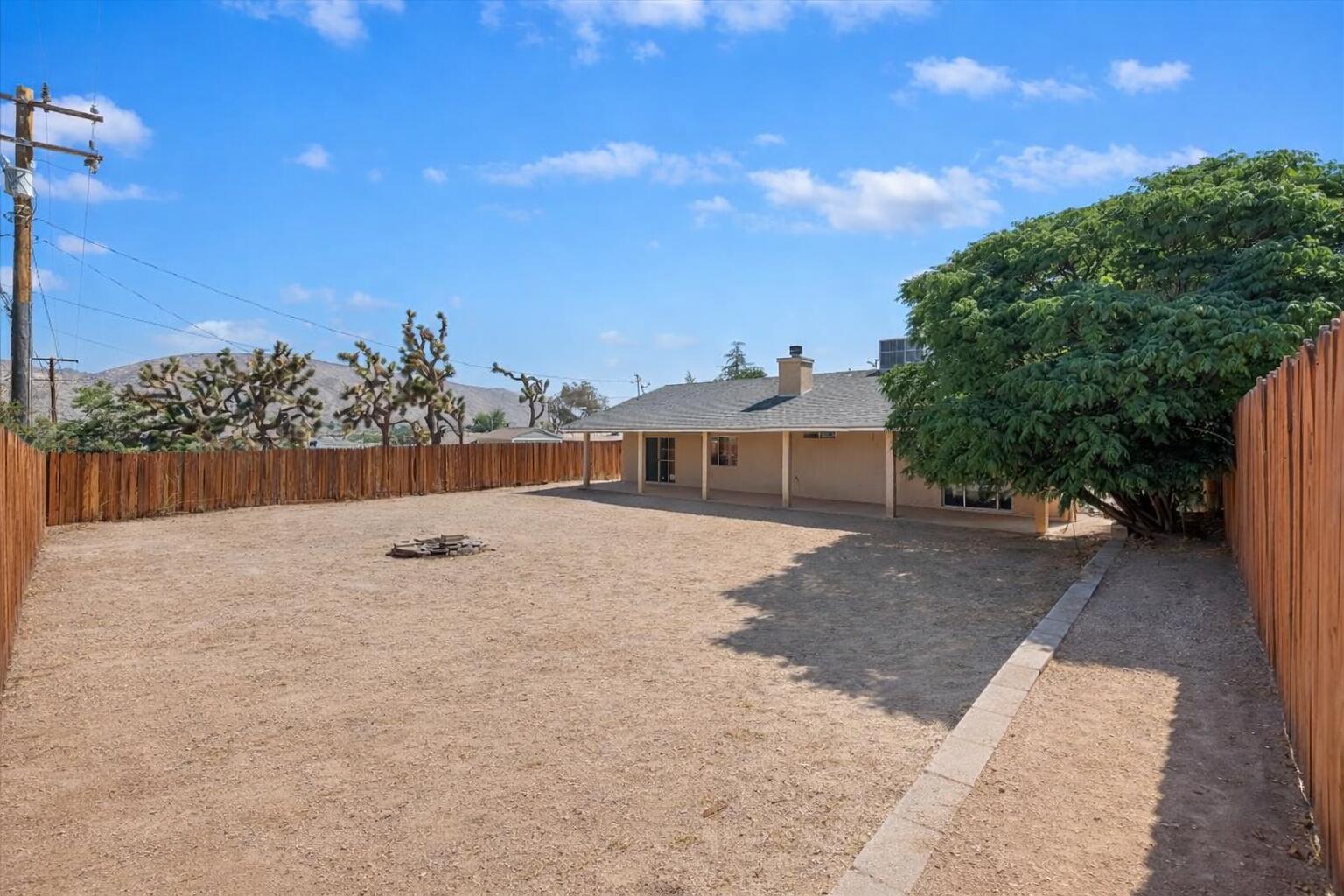 7562 Inca Trail Yucca Valley, CA 92284 - Photo 27 of 30 a view of a house with a yard