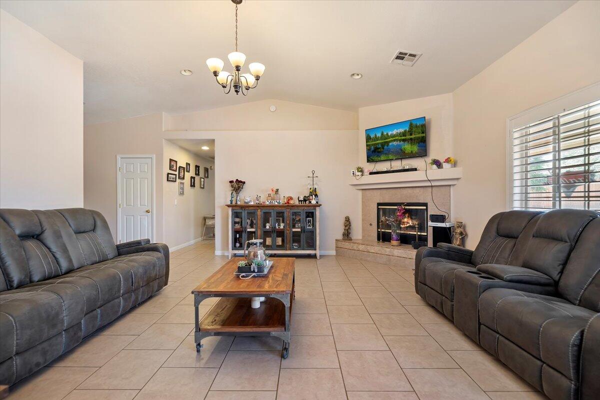 7562 Inca Trail Yucca Valley, CA 92284 - Photo 8 of 30 a living room with furniture a fireplace and a flat screen tv