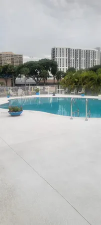 a view of a swimming pool and a yard