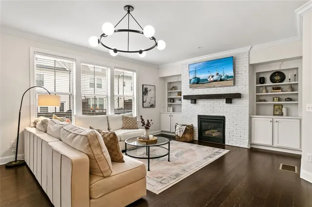 a living room with furniture a fireplace and a flat screen tv