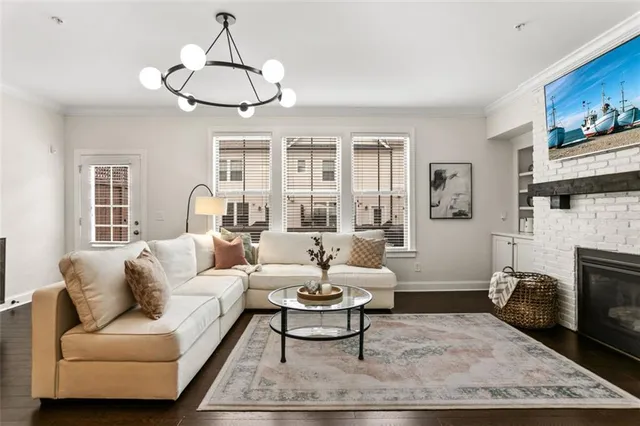 a living room with furniture a fireplace and white walls