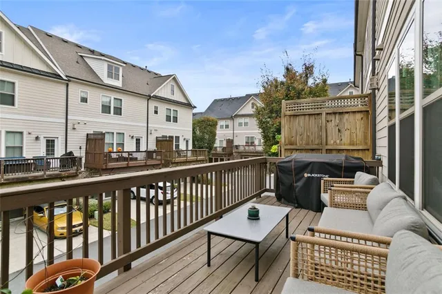 a balcony with furniture and a potted plant