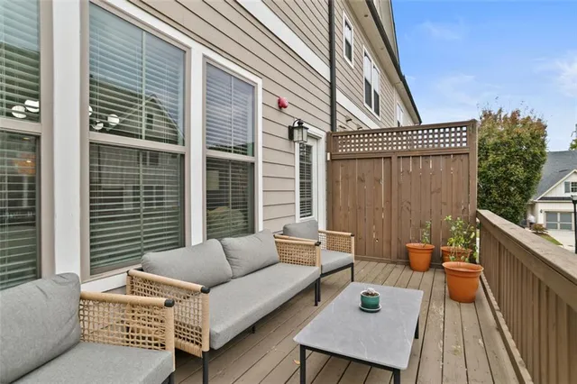 a balcony with furniture and a potted plant