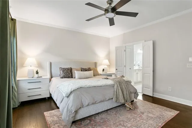 a spacious bedroom with a bed and wooden floor
