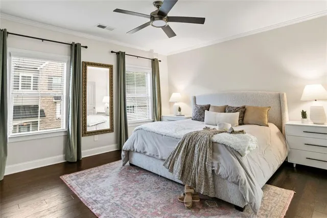 a spacious bedroom with a bed and wooden floor