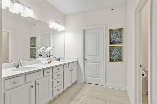a bathroom with a double vanity sink and a mirror
