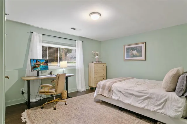 a bedroom with a bed a table and chair