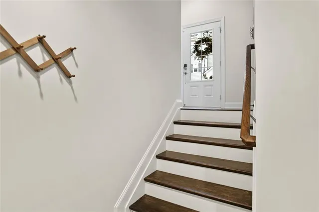 a view of entryway with wooden floor and stairs