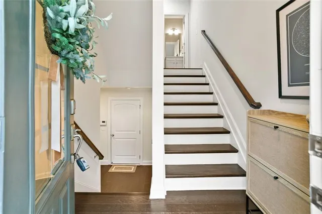a view of entryway with wooden floor and stairs