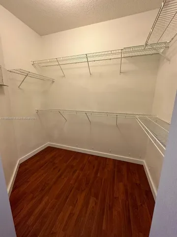 a bathroom with a double vanity sink a mirror and a bathtub