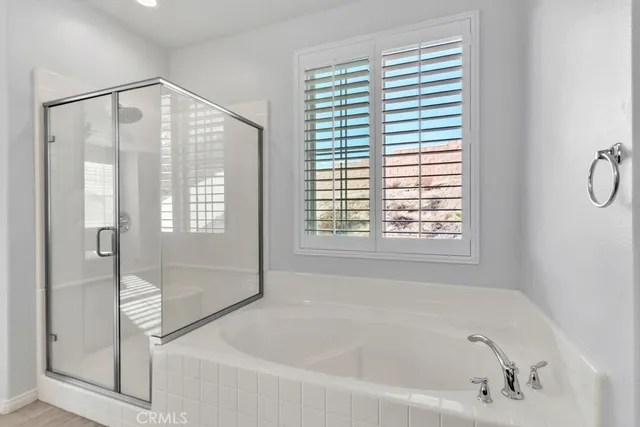 a bathroom with a sink double vanity granite tub and a mirror