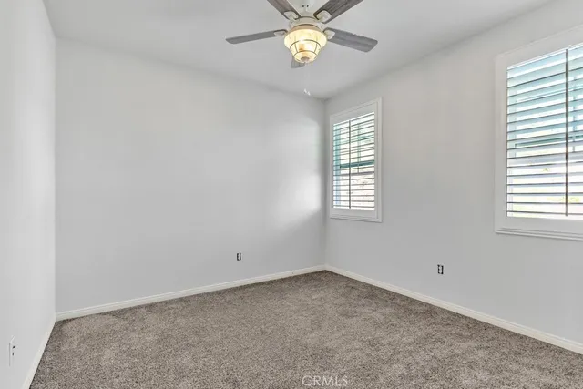 a view of a white house with a yard