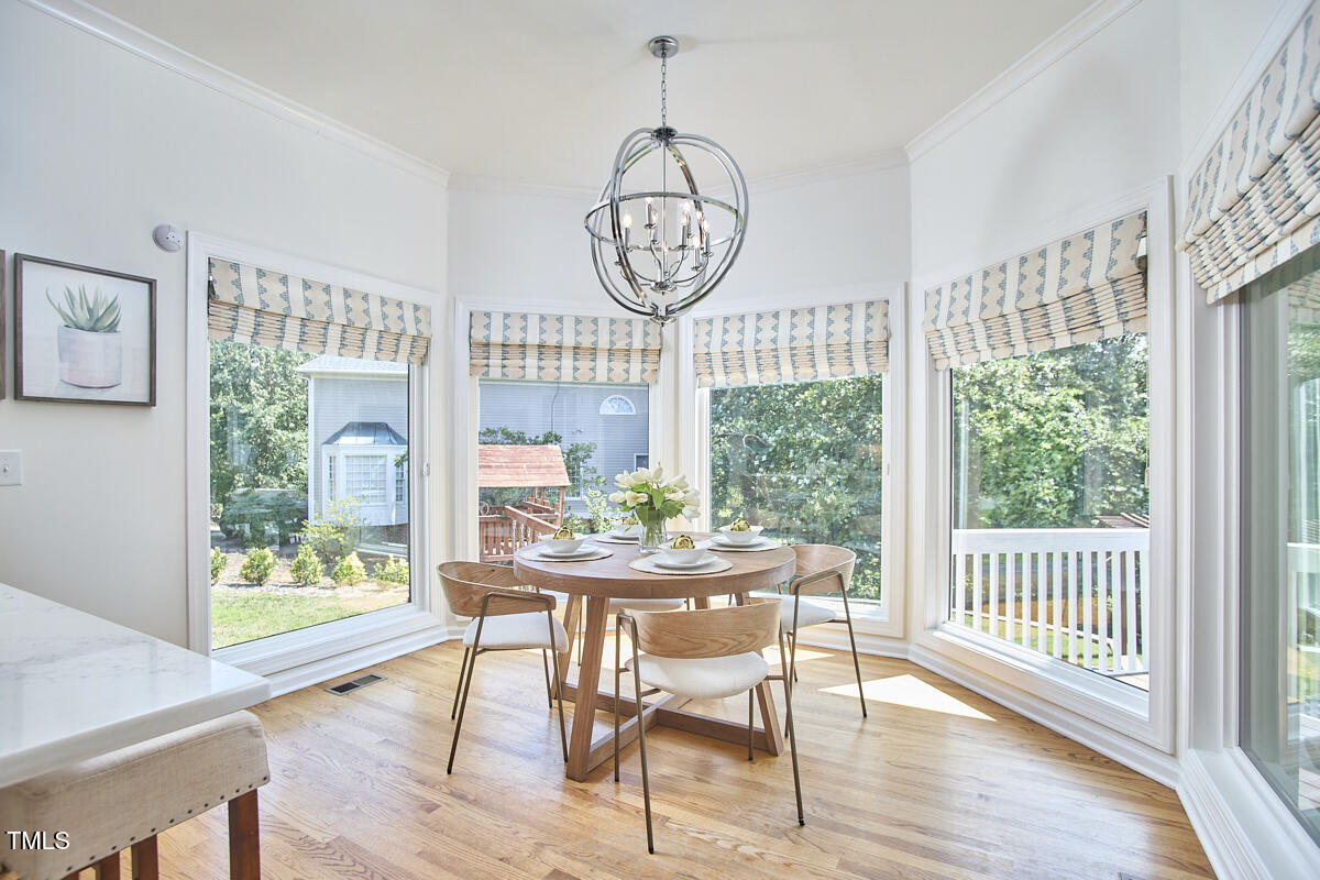 4303 Thetford Road Durham, NC 27707 - Photo 21 of 88 a view of a dining room with furniture window and wooden floor
