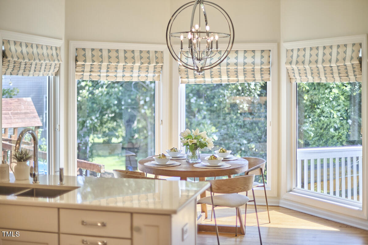 4303 Thetford Road Durham, NC 27707 - Photo 22 of 88 a view of a dining room with furniture window and wooden floor