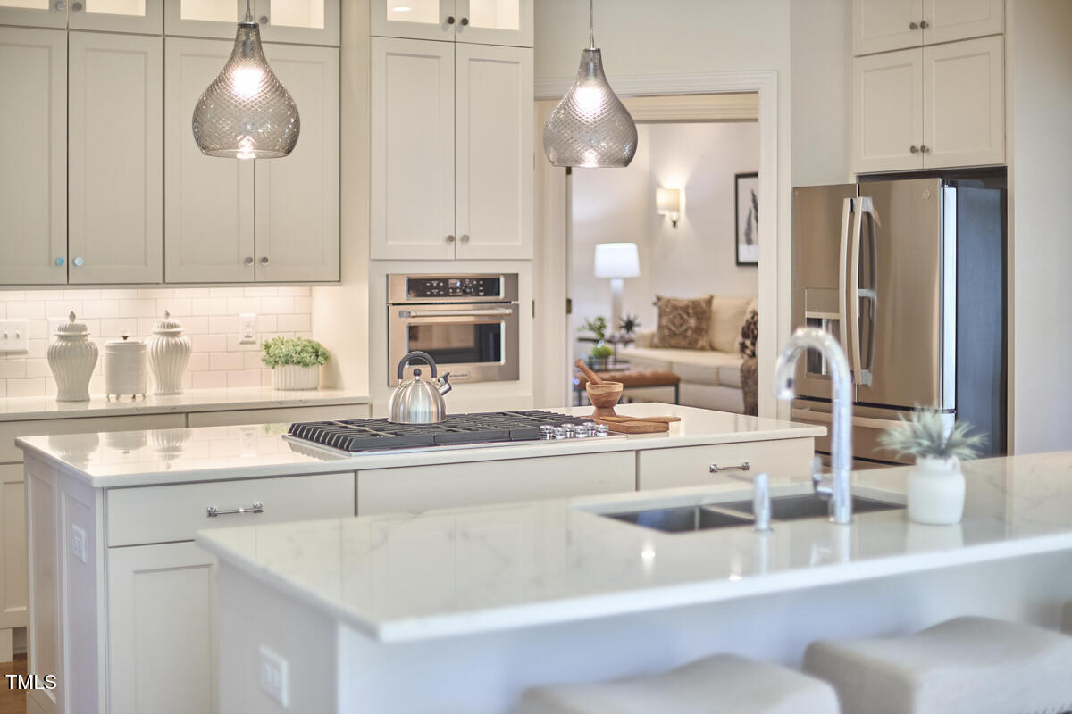 4303 Thetford Road Durham, NC 27707 - Photo 24 of 88 a kitchen with stainless steel appliances granite countertop a sink and a white cabinets