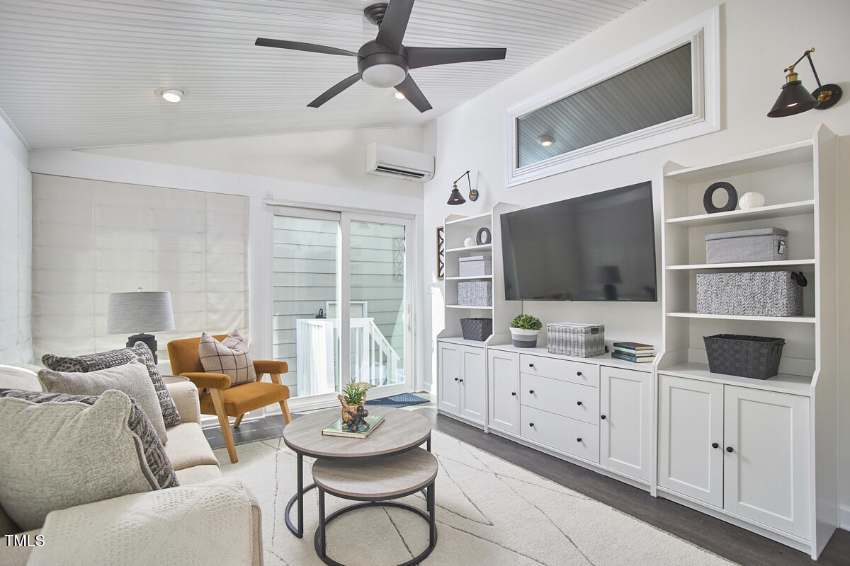 4303 Thetford Road Durham, NC 27707 - Photo 33 of 88 a living room with furniture and a flat screen tv