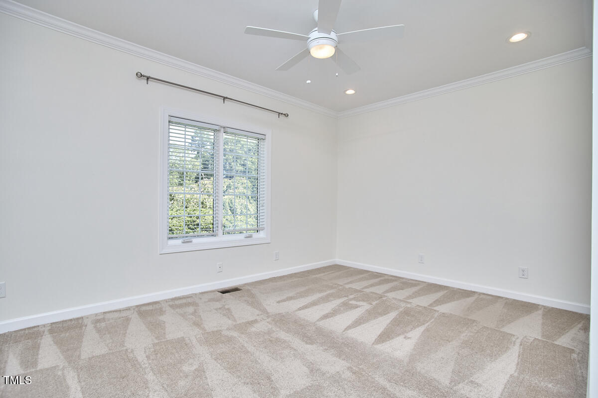 4303 Thetford Road Durham, NC 27707 - Photo 37 of 88 an empty room with a window and a fan