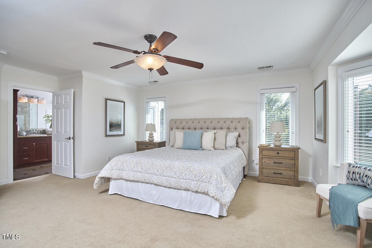 4303 Thetford Road Durham, NC 27707 - Photo 41 of 88 a bedroom with a bed chandelier and a window