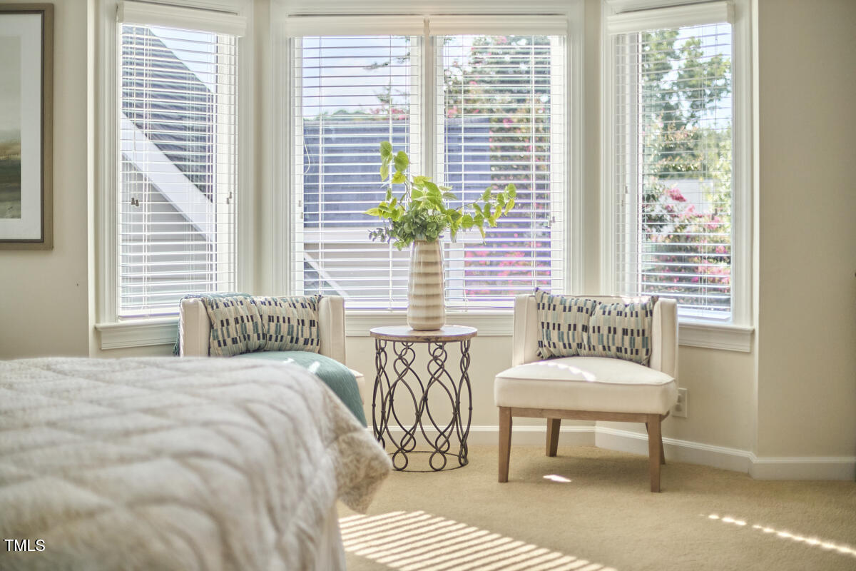 4303 Thetford Road Durham, NC 27707 - Photo 43 of 88 a bedroom with a bed and a chair