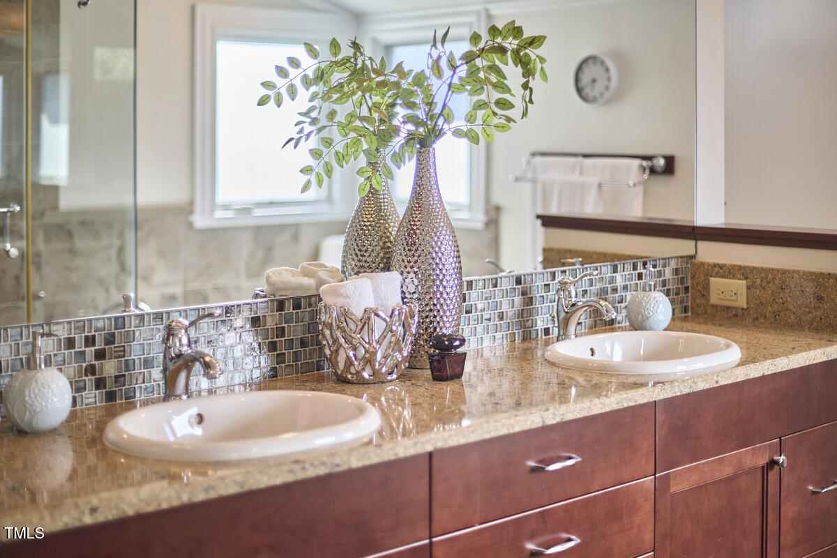 4303 Thetford Road Durham, NC 27707 - Photo 46 of 88 a bathroom with a sink and a mirror