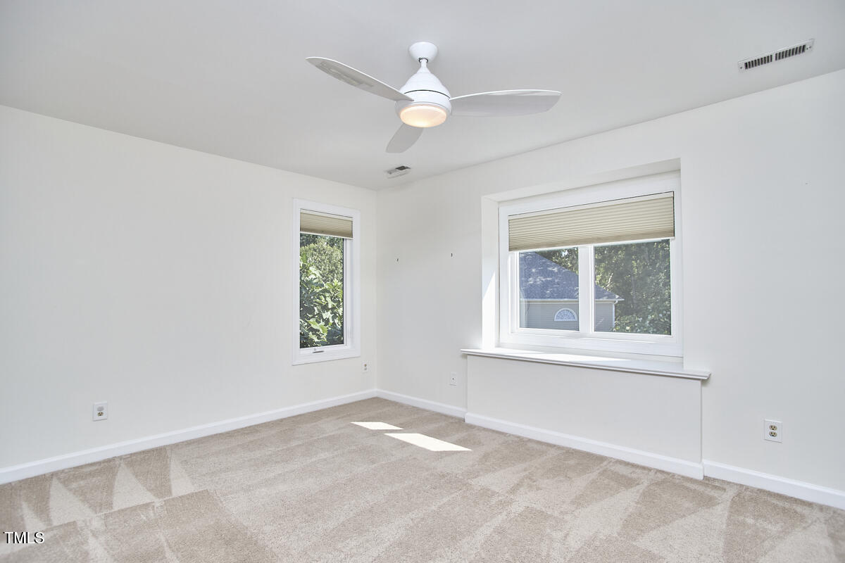4303 Thetford Road Durham, NC 27707 - Photo 51 of 88 an empty room with a window and a fan