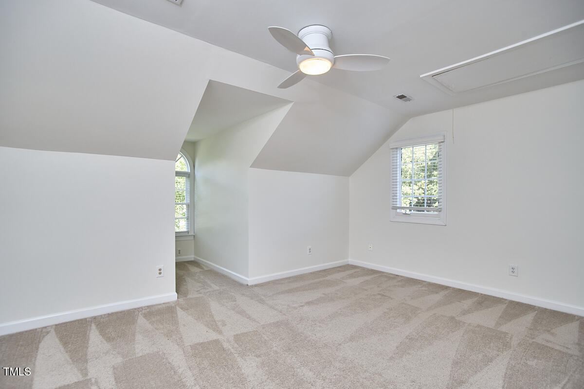 4303 Thetford Road Durham, NC 27707 - Photo 53 of 88 an empty room with a chandelier fan and windows
