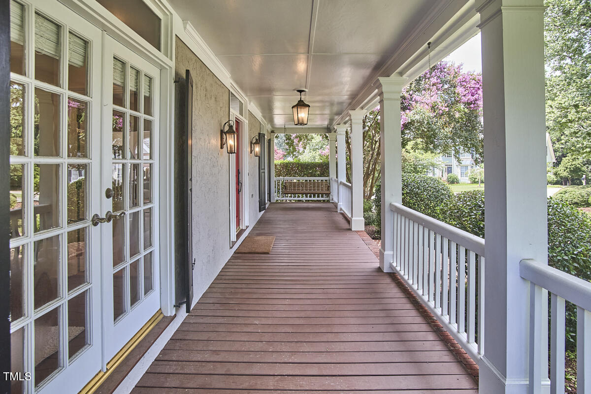 4303 Thetford Road Durham, NC 27707 - Photo 5 of 88 a view of a porch with wooden floor and stairs