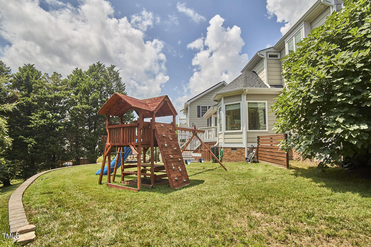 4303 Thetford Road Durham, NC 27707 - Photo 63 of 88 a view of a house with backyard porch and sitting area