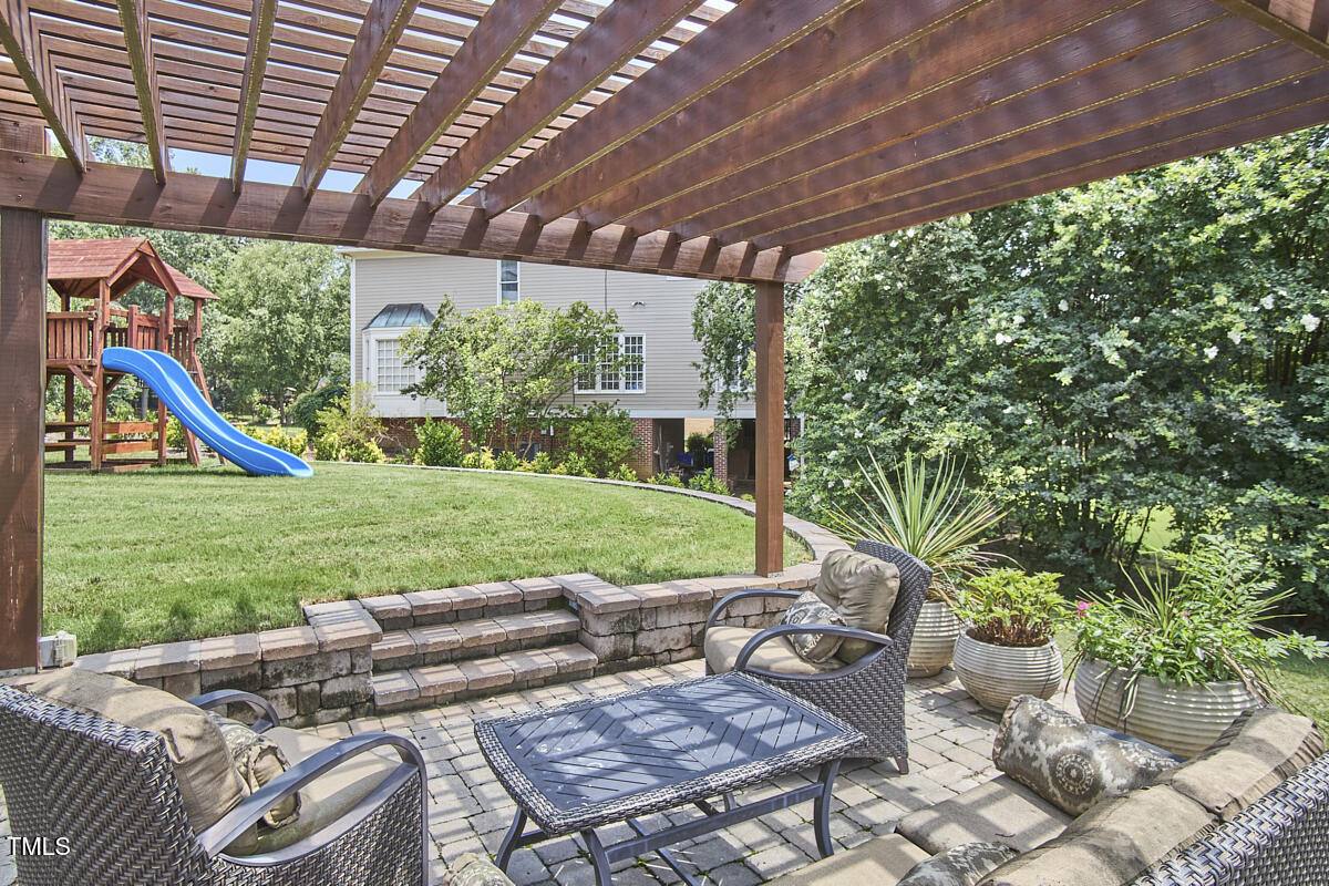 4303 Thetford Road Durham, NC 27707 - Photo 65 of 88 a view of a backyard with furniture and garden