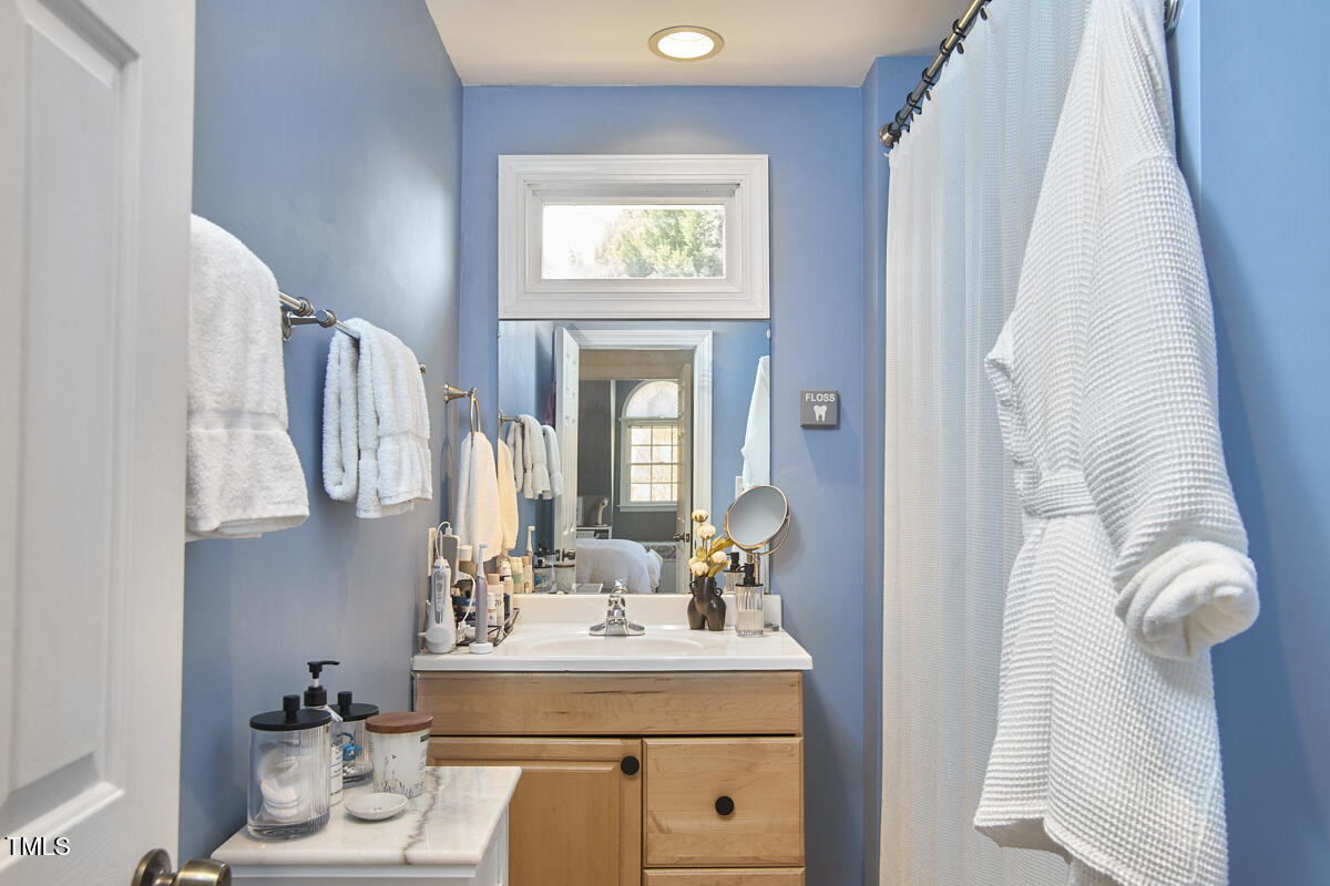 4303 Thetford Road Durham, NC 27707 - Photo 86 of 88 a bathroom with a sink mirror and vanity