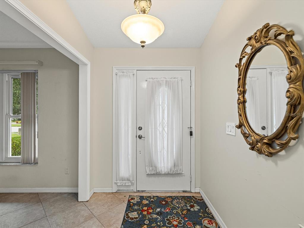 12595 93rd Way North Largo, FL 33773 - Photo 11 of 53 a view of a livingroom with wooden floor and a large window