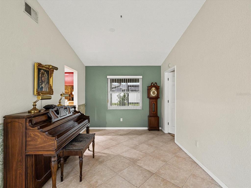 12595 93rd Way North Largo, FL 33773 - Photo 14 of 53 a living room with furniture a piano and a window