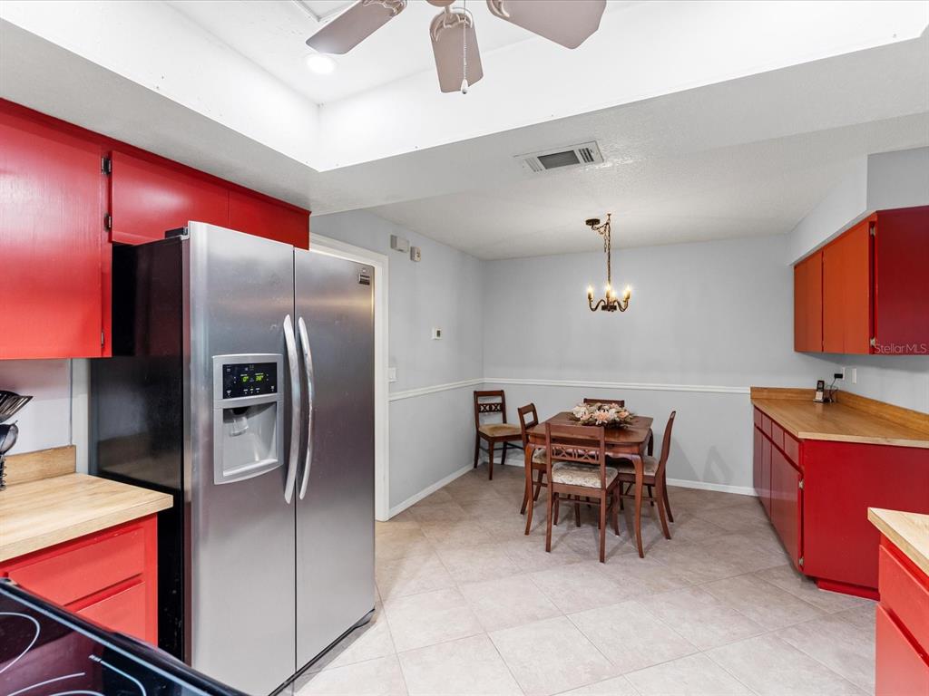 12595 93rd Way North Largo, FL 33773 - Photo 21 of 53 a kitchen with stainless steel appliances granite countertop a refrigerator and a stove