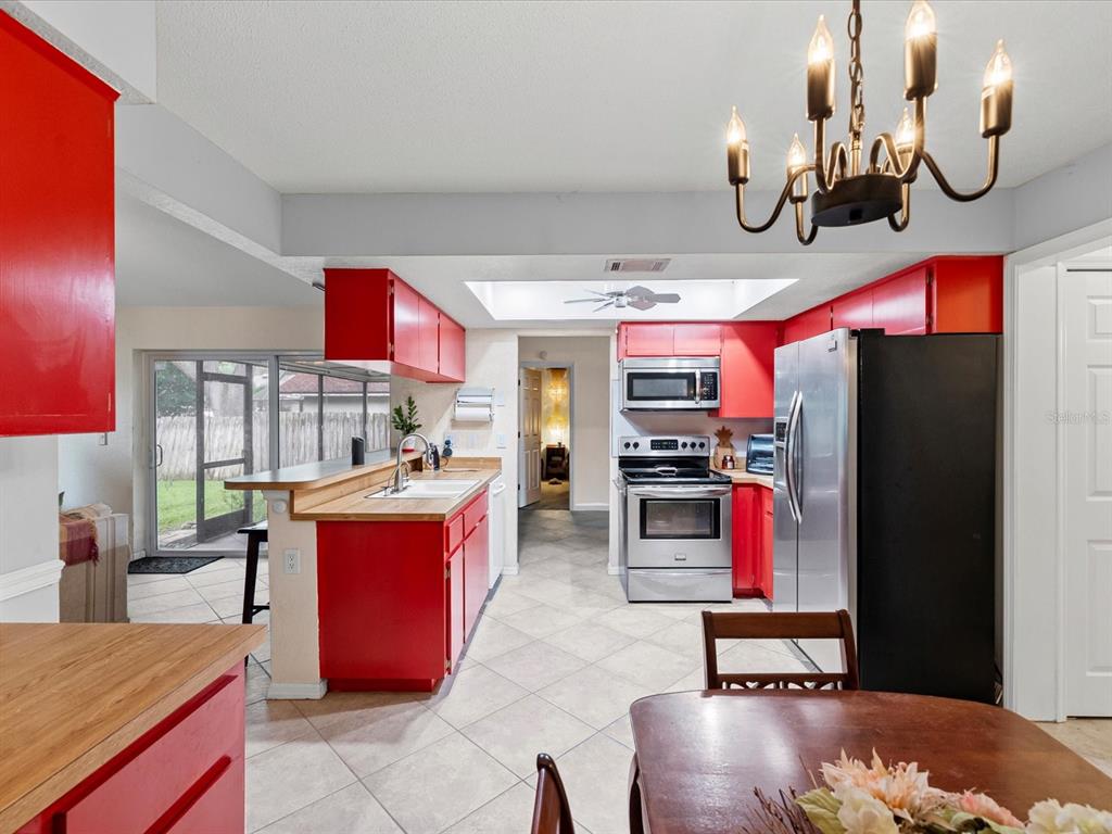 12595 93rd Way North Largo, FL 33773 - Photo 22 of 53 a kitchen with stainless steel appliances granite countertop a sink dishwasher stove and refrigerator