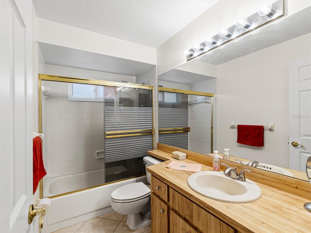 12595 93rd Way North Largo, FL 33773 - Photo 28 of 53 a bathroom with a sink toilet and shower