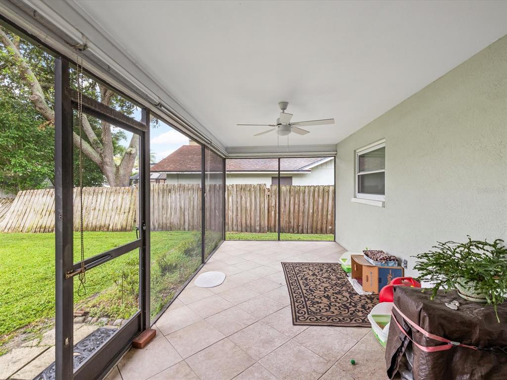 12595 93rd Way North Largo, FL 33773 - Photo 32 of 53 a living room with furniture and a floor to ceiling window