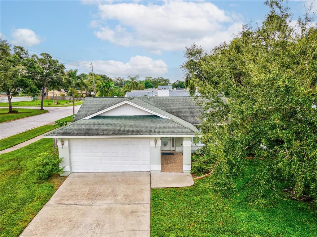 12595 93rd Way North Largo, FL 33773 - Photo 40 of 53 a front view of a house with a yard and trees