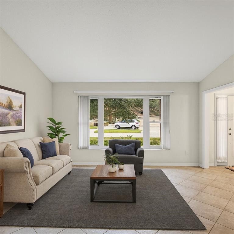 12595 93rd Way North Largo, FL 33773 - Photo 4 of 53 a living room with furniture and a large window