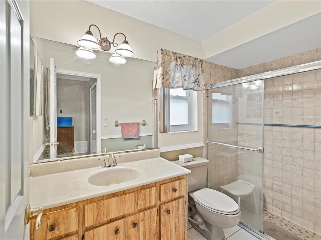 12595 93rd Way North Largo, FL 33773 - Photo 10 of 53 a bathroom with a toilet sink and mirror